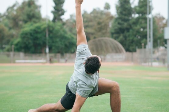 man-in-black-and-white-t-shirt-and-black-shorts-sitting-on-green-grass-field-during.jpg man in black and white t-shirt and black shorts sitting on green grass field during